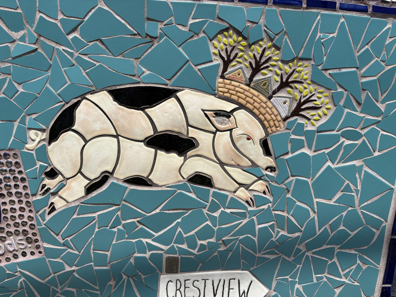 Domino the pig set in tile on the neighborhood mosaic mural